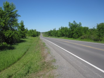 The County road at the entrance to the farm